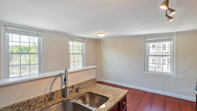 141 State St Unit 2, Newburyport, MA 01950 - kitchen with hardwood / wood-style flooring, a sink, baseboards, light stone counters, and crown molding