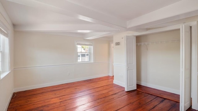 141 State St Unit 2, Newburyport, MA 01950 - unfurnished bedroom with hardwood / wood-style floors, a closet, baseboards, and beamed ceiling