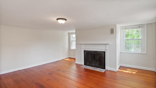 141 State St Unit 2, Newburyport, MA 01950 - unfurnished living room with a fireplace with flush hearth, hardwood / wood-style flooring, plenty of natural light, and baseboards