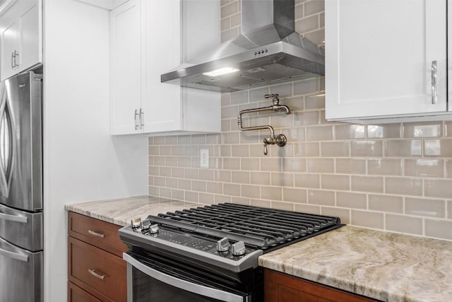 37 Gorham St, Chelmsford, MA 01824 - kitchen featuring appliances with stainless steel finishes, wall chimney range hood, white cabinets, and tasteful backsplash