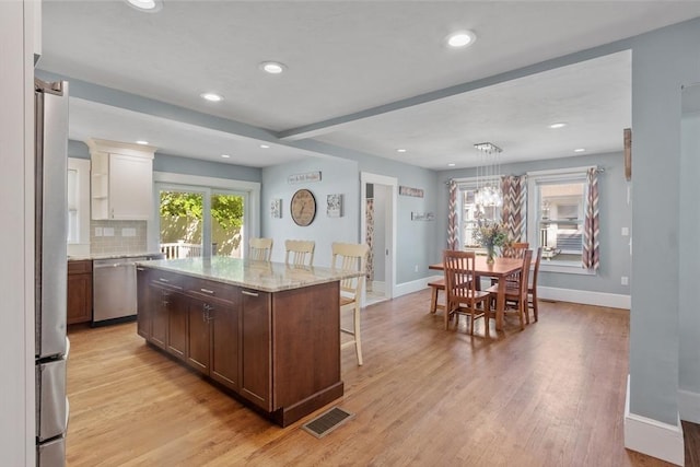 37 Gorham St, Chelmsford, MA 01824 - kitchen with appliances with stainless steel finishes, a kitchen bar, light wood-style flooring, baseboards, and recessed lighting