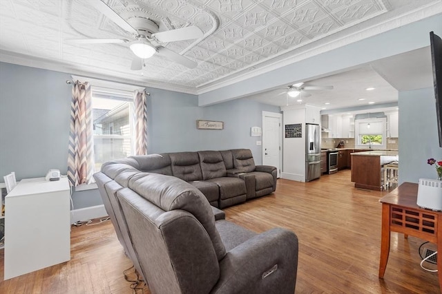 37 Gorham St, Chelmsford, MA 01824 - living room with ceiling fan, light wood-type flooring, an ornate ceiling, plenty of natural light, and baseboards
