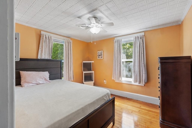 37 Gorham St, Chelmsford, MA 01824 - bedroom with multiple windows, baseboards, light wood finished floors, and a ceiling fan