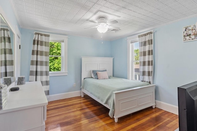 37 Gorham St, Chelmsford, MA 01824 - bedroom featuring multiple windows, baseboards, wood-type flooring, and a ceiling fan