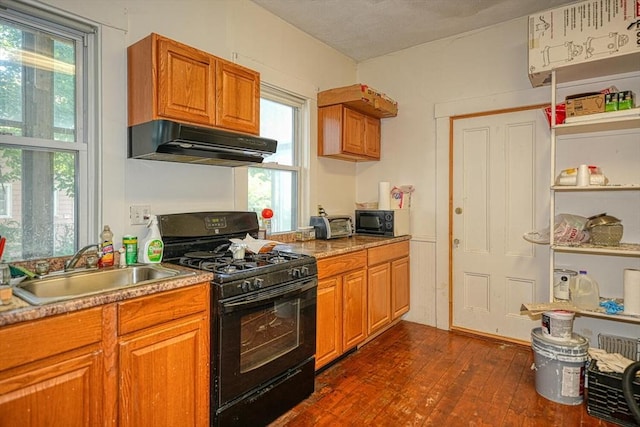 7 Prospect St, Woburn, MA 01801 - kitchen featuring black appliances, under cabinet range hood, a sink, dark wood finished floors, and brown cabinetry
