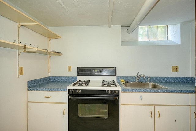 7 Prospect St, Woburn, MA 01801 - kitchen featuring range with gas stovetop, a sink, dark countertops, and open shelves