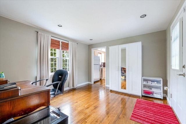 office space featuring light wood-style floors and baseboards