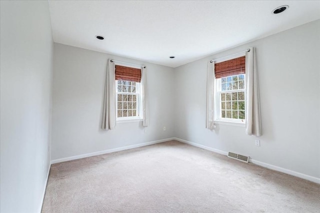 carpeted empty room with baseboards and visible vents