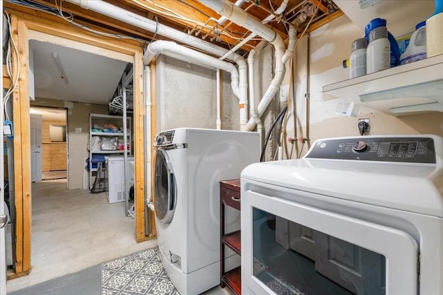clothes washing area with laundry area and washer and clothes dryer