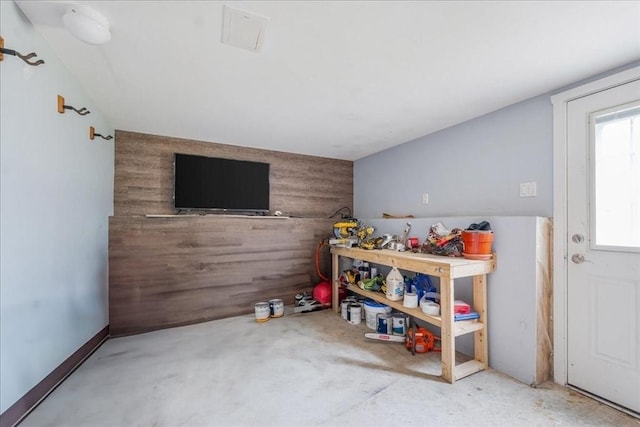 recreation room with wooden walls and an accent wall