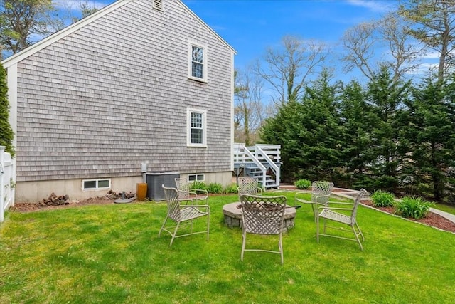 back of house featuring a yard, cooling unit, stairs, and an outdoor fire pit