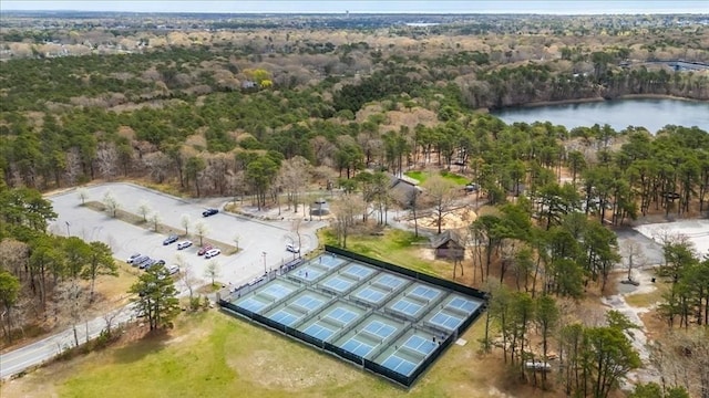 drone / aerial view featuring a water view and a wooded view