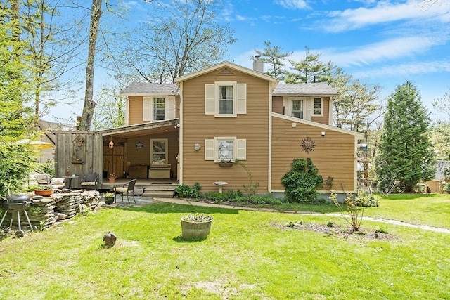 back of property featuring a lawn and a chimney