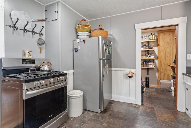 kitchen featuring appliances with stainless steel finishes and dark stone finish floors