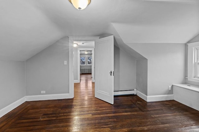 bonus room with dark wood-type flooring, a baseboard radiator, and vaulted ceiling