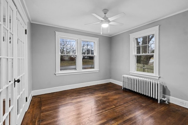 unfurnished room with a wealth of natural light, radiator heating unit, and ornamental molding