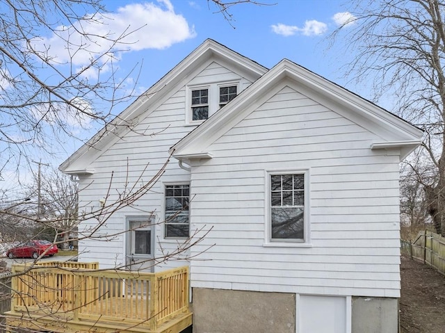 rear view of property featuring a deck