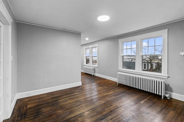 unfurnished room featuring crown molding, radiator, and dark hardwood / wood-style floors