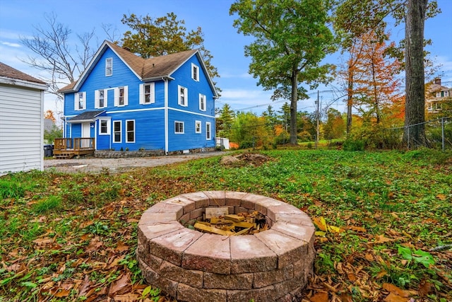 exterior space featuring a fire pit and a wooden deck