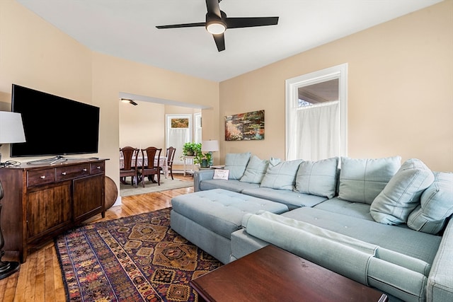 living room featuring ceiling fan and light hardwood / wood-style flooring