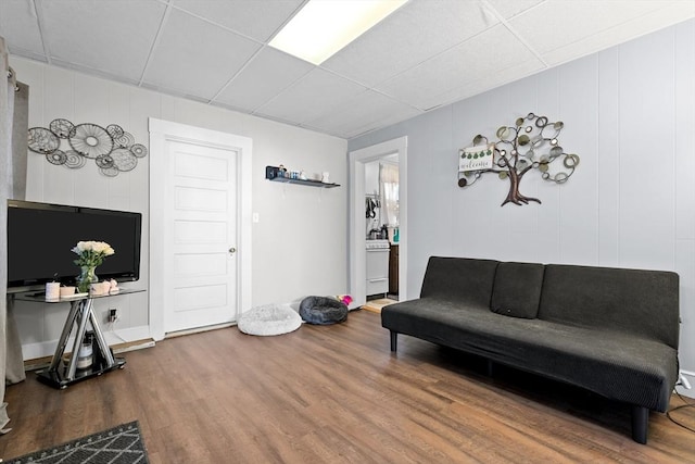 73 Lincoln Ave, Saugus, MA 01906 - living room with a paneled ceiling, wood finished floors, and a decorative wall