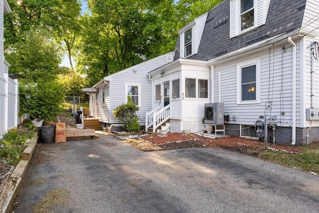 73 Lincoln Ave, Saugus, MA 01906 - rear view of house with a shingled roof, a cooling unit, and entry steps