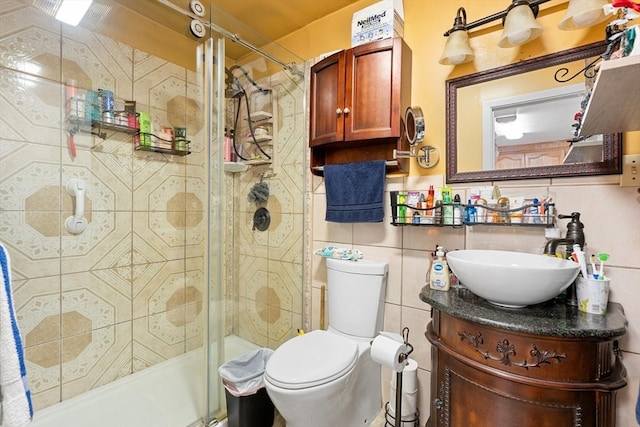 73 Lincoln Ave, Saugus, MA 01906 - bathroom featuring a shower stall, tile walls, vanity, and toilet