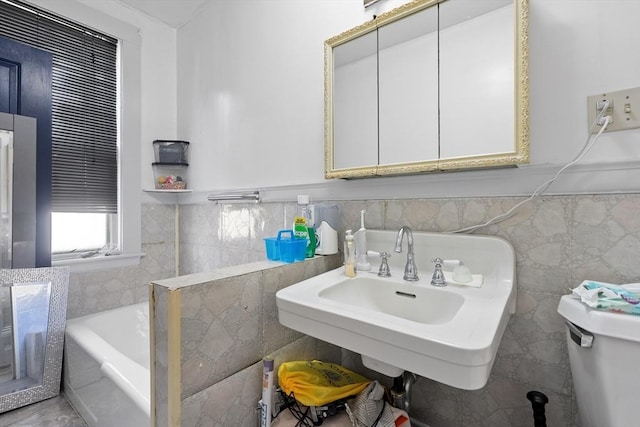73 Lincoln Ave, Saugus, MA 01906 - full bath with a garden tub, toilet, tile walls, a sink, and wainscoting