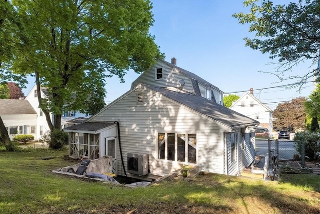 73 Lincoln Ave, Saugus, MA 01906 - back of property with a sunroom, a chimney, ac unit, and a shingled roof