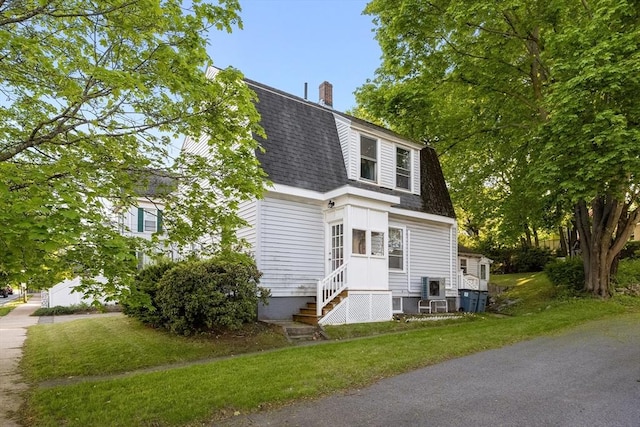 73 Lincoln Ave, Saugus, MA 01906 - dutch colonial with roof with shingles, a chimney, a front yard, and entry steps