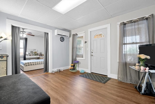 73 Lincoln Ave, Saugus, MA 01906 - entryway featuring a wall mounted air conditioner, wood finished floors, baseboards, and a drop ceiling