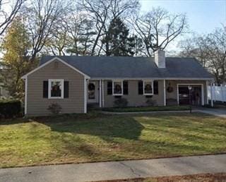 view of front of house featuring an attached garage, driveway, and a front lawn