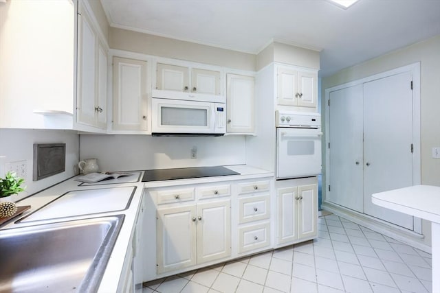 33 Page Rd, North Attleboro, MA 02760 - kitchen with white appliances, white cabinetry, light countertops, and light tile patterned flooring