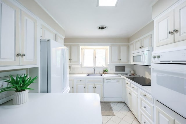 33 Page Rd, North Attleboro, MA 02760 - kitchen with white appliances, white cabinetry, ornamental molding, and light countertops