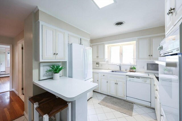 33 Page Rd, North Attleboro, MA 02760 - kitchen with white appliances, white cabinetry, and light countertops