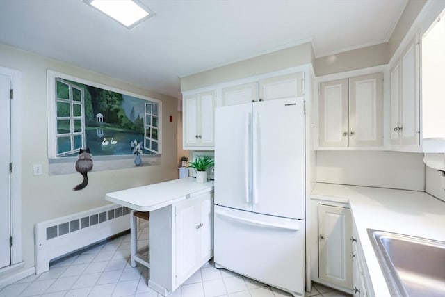 33 Page Rd, North Attleboro, MA 02760 - kitchen featuring freestanding refrigerator, radiator heating unit, light countertops, and white cabinets