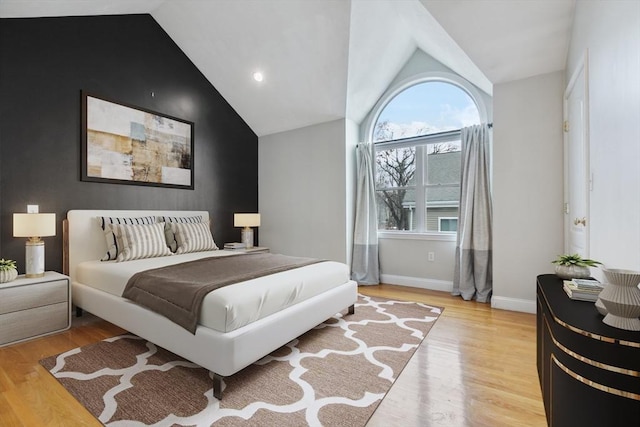 bedroom featuring lofted ceiling and light hardwood / wood-style floors