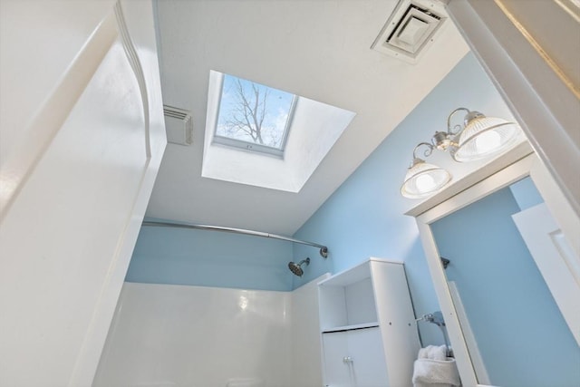 bathroom featuring a skylight