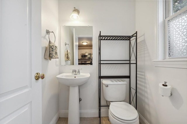 bathroom with tile patterned floors, toilet, and sink