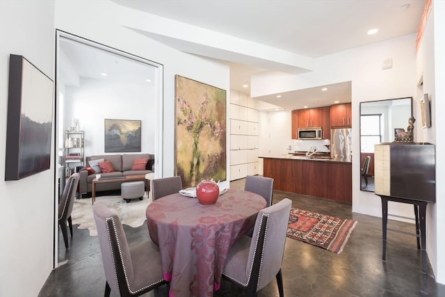 dining room featuring recessed lighting and concrete floors