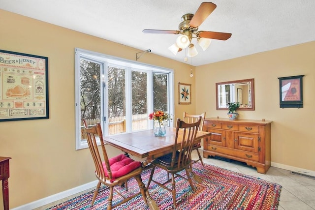 tiled dining room with ceiling fan