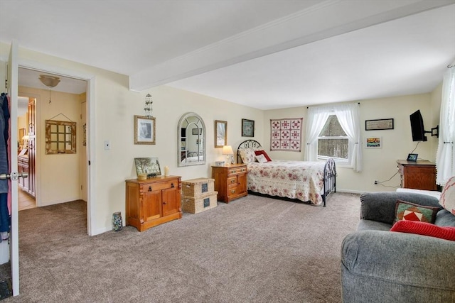 bedroom with beam ceiling and carpet floors