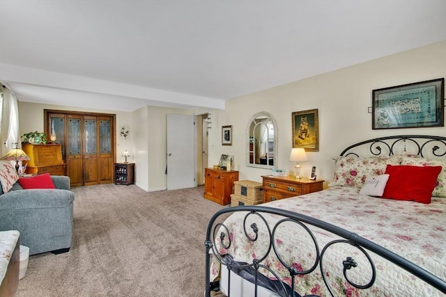 bedroom featuring light colored carpet