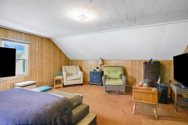 bedroom featuring vaulted ceiling, carpet flooring, and wood walls