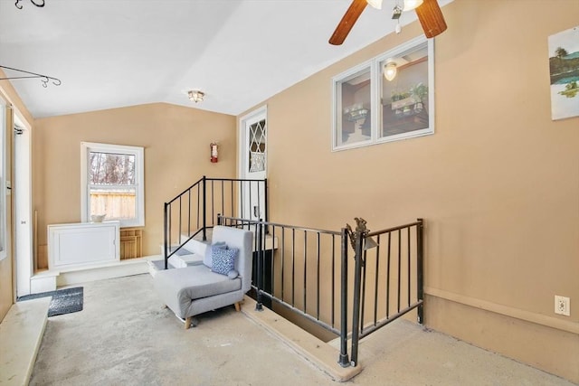 sitting room featuring concrete flooring and lofted ceiling