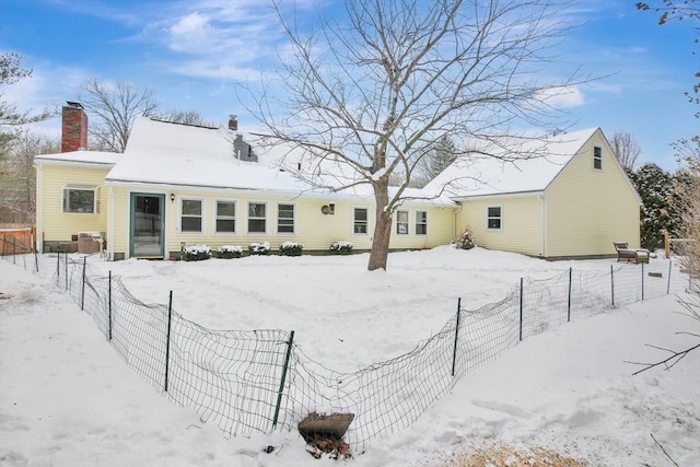 view of snow covered rear of property