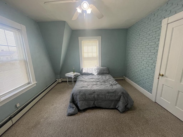 carpeted bedroom featuring baseboard heating, a baseboard heating unit, multiple windows, and ceiling fan