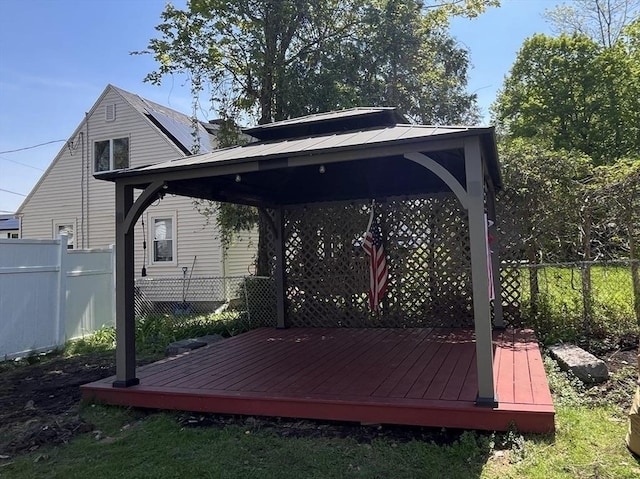 deck featuring a gazebo and fence