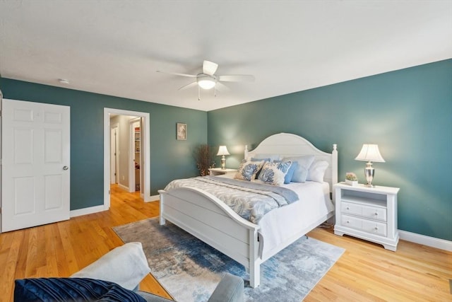 bedroom with baseboards, ceiling fan, and wood finished floors
