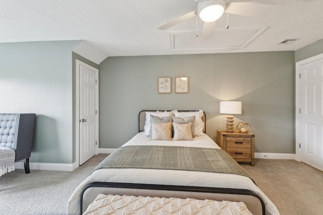 bedroom featuring visible vents, baseboards, attic access, ceiling fan, and carpet flooring